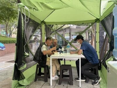 찾탕 천막에서 식사 중인 노숙인들과 이대유(오른쪽) 찾탕 대표. /유민선 청년기자